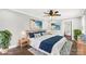 Staged bedroom with a ceiling fan, ceiling trim, and beach-themed paintings above the bed at 330 Skyview Dr, Catawba, SC 29704