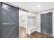 Inviting entryway with a stylish sliding barn door, convenient coat rack, and attractive gray front door at 330 Skyview Dr, Catawba, SC 29704