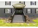 Inviting front porch with decorative door, complemented by landscaped garden and steps at 330 Skyview Dr, Catawba, SC 29704