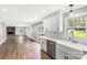 Bright kitchen open to living room featuring white cabinets, subway tile, and modern fixtures at 330 Skyview Dr, Catawba, SC 29704