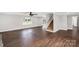 Bright living room featuring hardwood floors, coffered ceiling, a staircase and a window at 330 Skyview Dr, Catawba, SC 29704