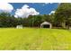 View of backyard with outbuildings and a well-maintained lawn area, perfect for country living at 330 Skyview Dr, Catawba, SC 29704