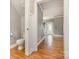 A half-bathroom adjacent to a hallway with hardwood floors at 3906 Balsam St, Indian Trail, NC 28079