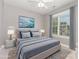Staged bedroom featuring a bed with blue pillows, a window, and tasteful decor at 3906 Balsam St, Indian Trail, NC 28079