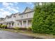 Attractive two-story home featuring a charming front porch and lush green landscaping at 3906 Balsam St, Indian Trail, NC 28079