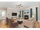 Cozy living room featuring a fireplace, ceiling fan, and comfortable seating arrangement at 3906 Balsam St, Indian Trail, NC 28079
