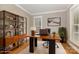 Office space with hardwood floors, large desk, bookshelf, and natural light at 3906 Balsam St, Indian Trail, NC 28079