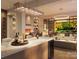 Open-concept kitchen features island seating, a fireplace, and glass doors opening to a bright outdoor living area at 409 Queens Rd # 401, Charlotte, NC 28207
