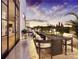 A stylish outdoor dining area offers city skyline views at sunset, with seating for eight on a spacious terrace at 409 Queens Rd # 401, Charlotte, NC 28207