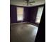 Bedroom featuring purple walls, two windows, and laminate flooring at 415 Orange St, Shelby, NC 28150