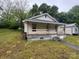 Charming home featuring a cozy front porch and a well-maintained lawn at 415 Orange St, Shelby, NC 28150