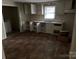 The kitchen has white cabinetry, a double basin stainless steel sink and lots of floor space at 415 Orange St, Shelby, NC 28150