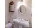 Elegant powder room with a pedestal sink, decorative mirror, and classic fixtures at 416 E Park Ave, Charlotte, NC 28203