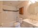 A bathroom features a tiled shower/bath, toilet, and sink with a decorative mirror and updated lighting at 416 E Park Ave, Charlotte, NC 28203