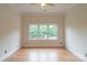 Bright bedroom featuring hardwood floors and a triple window offering natural light at 416 E Park Ave, Charlotte, NC 28203