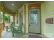 Inviting front porch with seating, a decorative door, and intricate trim details at 416 E Park Ave, Charlotte, NC 28203