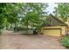 Exterior view of detached garage with driveway and lush landscaping at 416 E Park Ave, Charlotte, NC 28203