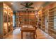 Home office with custom built-in shelving, a ceiling fan, and wood floors at 416 E Park Ave, Charlotte, NC 28203