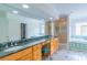 The main bathroom features double sinks, a large mirror, walk in shower, and a soaking tub at 416 E Park Ave, Charlotte, NC 28203