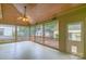 Screened-in porch with wood ceiling and fan, ideal for outdoor enjoyment at 416 E Park Ave, Charlotte, NC 28203