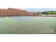 Community tennis courts with school in background at 416 E Park Ave, Charlotte, NC 28203