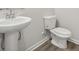 Bathroom featuring a pedestal sink, toilet, and modern fixtures set against neutral walls at 417 Bent Burr Crk, York, SC 29745