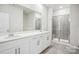 Bathroom with double sinks, a large mirror, and a tiled shower with glass doors at 417 Bent Burr Crk, York, SC 29745