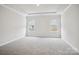 Neutral bedroom with a tray ceiling, carpet floors, and two windows at 417 Bent Burr Crk, York, SC 29745