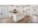 Modern, open kitchen with white cabinetry, granite countertops, stainless steel appliances, and wood-style flooring at 417 Bent Burr Crk, York, SC 29745