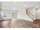 Open living room with wood-look floors, a window, and sliding glass door to the backyard at 417 Bent Burr Crk, York, SC 29745
