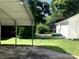 Backyard of a single-Gathering home, featuring a covered parking area and a small white storage shed at 447 17Th St, Cramerton, NC 28032