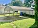 Wide carport, providing covered parking and shade, with a grassy lawn and sidewalk at 447 17Th St, Cramerton, NC 28032