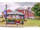 Community park featuring a gazebo with a speed limit sign of 20, flowers, and green grass at 447 17Th St, Cramerton, NC 28032
