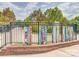 Close-up of a community area with a colorful fence and a brick retaining wall at 447 17Th St, Cramerton, NC 28032