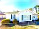 Inviting single-story home with a classic white exterior, green shutters, and neat landscaping at 447 17Th St, Cramerton, NC 28032