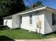 Side exterior view of a home with white siding and trim, with a green roof and well-maintained backyard at 447 17Th St, Cramerton, NC 28032