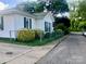 Well-maintained home with white siding, a green roof, and a neat sidewalk view at 447 17Th St, Cramerton, NC 28032