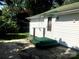 Back exterior of home with white siding, trim, and a door on a step with a green carpet at 447 17Th St, Cramerton, NC 28032