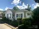 Charming single-story home featuring white siding, green shutters, and a well-maintained front yard at 447 17Th St, Cramerton, NC 28032