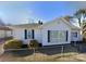 Inviting single-story home with a classic white exterior, green shutters, and neat landscaping at 447 17Th St, Cramerton, NC 28032