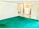 Living room features green carpet, partial wall partition, and an open view into the kitchen area at 447 17Th St, Cramerton, NC 28032