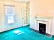 Comfortable living room with green carpet, decorative fireplace and a sunlit window at 447 17Th St, Cramerton, NC 28032