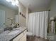 Well-maintained bathroom with granite countertop, white cabinets, and shower with curtain at 5062 Gribble Ln, Lancaster, SC 29720