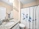 Bathroom featuring granite countertops, white cabinetry, and a shower with a floral shower curtain at 5062 Gribble Ln, Lancaster, SC 29720