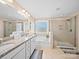 Bathroom featuring double vanity with granite countertop, large mirror, soaking tub, and glass shower at 5062 Gribble Ln, Lancaster, SC 29720