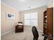 Bedroom with neutral walls, a large window, carpeted flooring, and a comfortable leather chair in the sitting area at 5062 Gribble Ln, Lancaster, SC 29720
