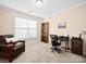 Bedroom with large window, carpeted flooring, and sitting area with a comfortable leather chair and small bookshelf at 5062 Gribble Ln, Lancaster, SC 29720