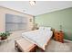 Bright bedroom featuring neutral walls, a wooden bed frame, and a cozy, inviting atmosphere at 5062 Gribble Ln, Lancaster, SC 29720