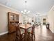 Open dining area with hardwood floors, chandelier, and seamlessly connected to the living room at 5062 Gribble Ln, Lancaster, SC 29720