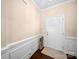 Welcoming foyer with white wainscoting, a neutral color palette, and a white door at 5062 Gribble Ln, Lancaster, SC 29720
